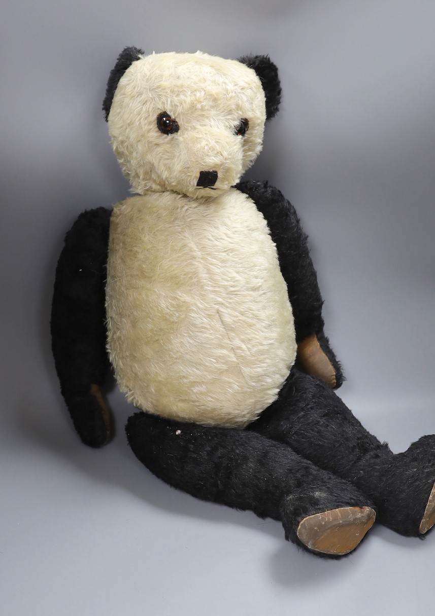 A large panda, 75cm, and a large cotton plush bear with waistcoat, 65cm